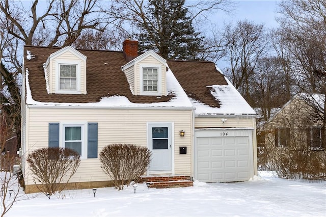 cape cod-style house featuring a garage