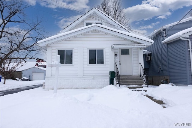 view of front of property featuring a garage and an outdoor structure