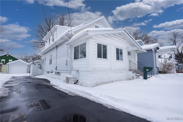 view of front of house with a garage and an outdoor structure