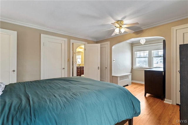 bedroom with crown molding, radiator heating unit, ceiling fan, and light hardwood / wood-style floors