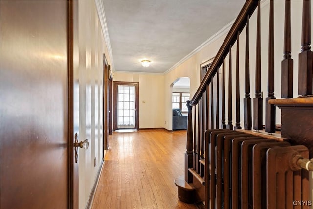 entryway featuring radiator heating unit, ornamental molding, and light hardwood / wood-style floors