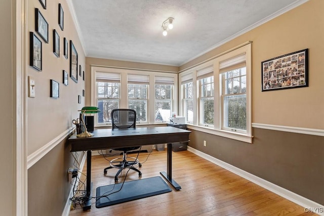 office space with crown molding and light wood-type flooring