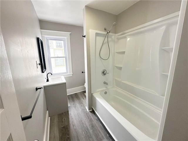 full bathroom with hardwood / wood-style flooring, vanity, toilet, and tub / shower combination