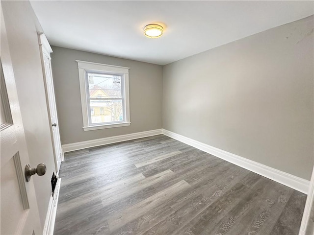 unfurnished room featuring dark hardwood / wood-style floors