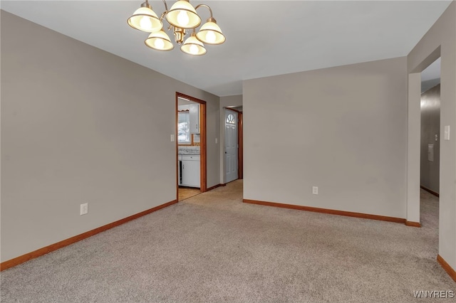 carpeted empty room with a notable chandelier