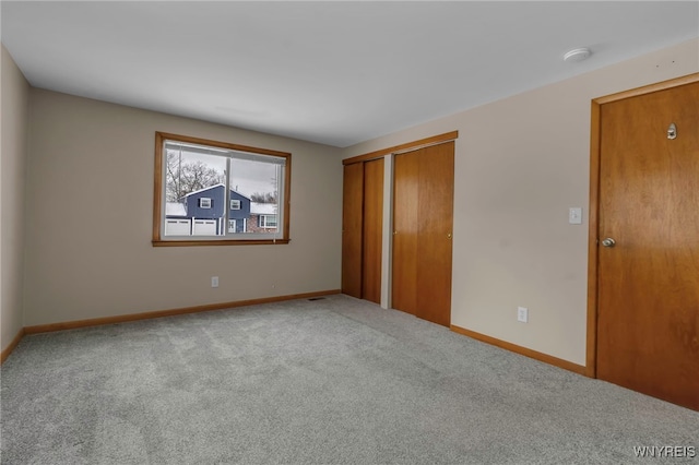 unfurnished bedroom featuring carpet flooring and a closet