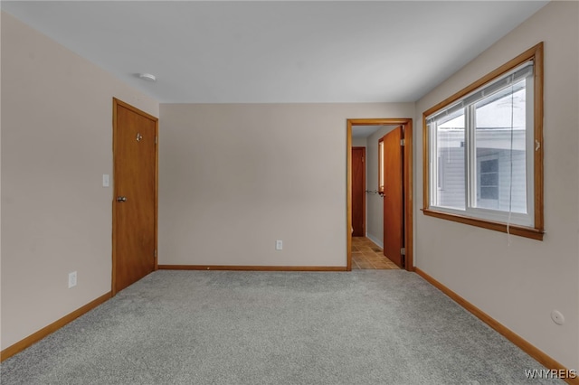 spare room featuring light colored carpet