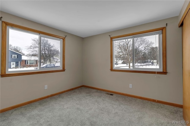 spare room featuring light colored carpet