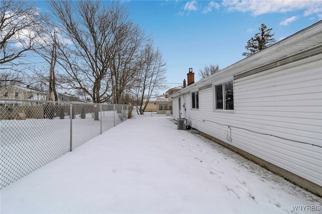 yard covered in snow with central AC unit