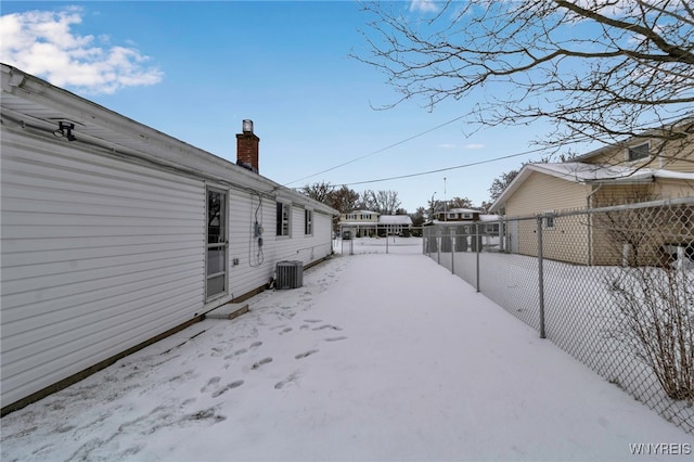 yard layered in snow with central AC unit