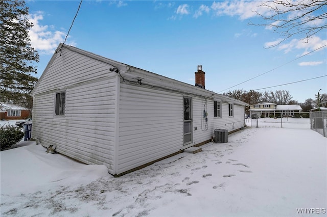 view of snowy exterior featuring cooling unit