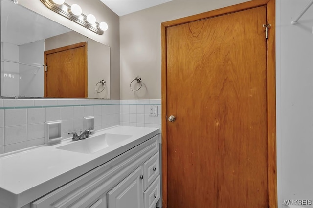 bathroom with tasteful backsplash and vanity