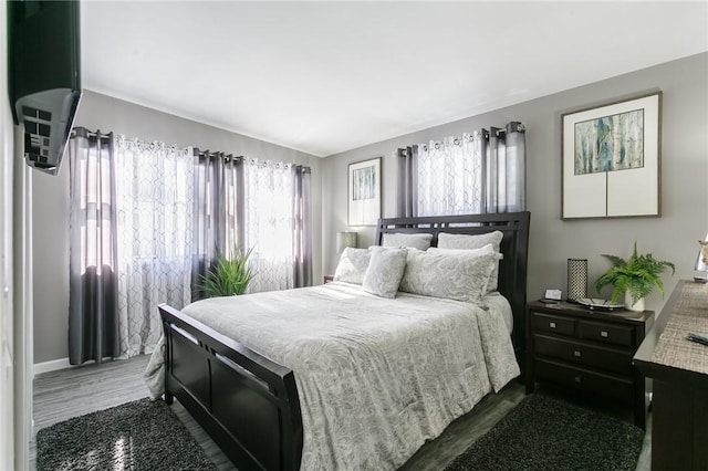 bedroom featuring dark hardwood / wood-style flooring and vaulted ceiling