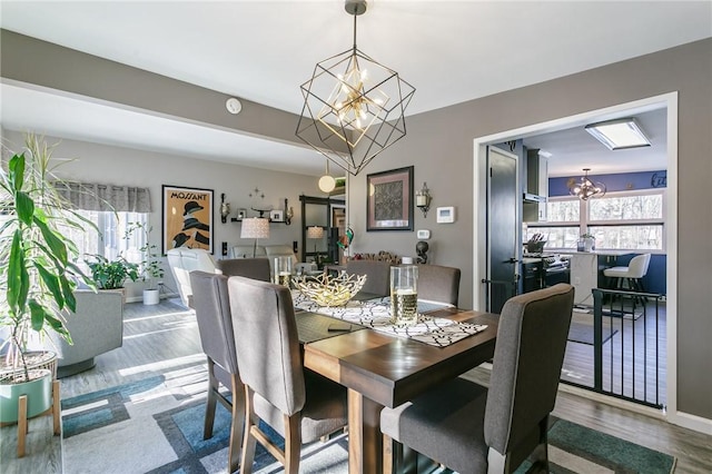 dining space featuring an inviting chandelier and wood-type flooring