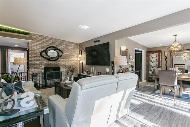 living room with a brick fireplace and light hardwood / wood-style flooring