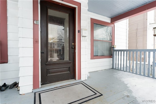 view of exterior entry featuring covered porch