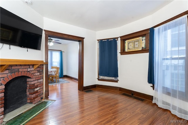 living room featuring hardwood / wood-style flooring and a fireplace