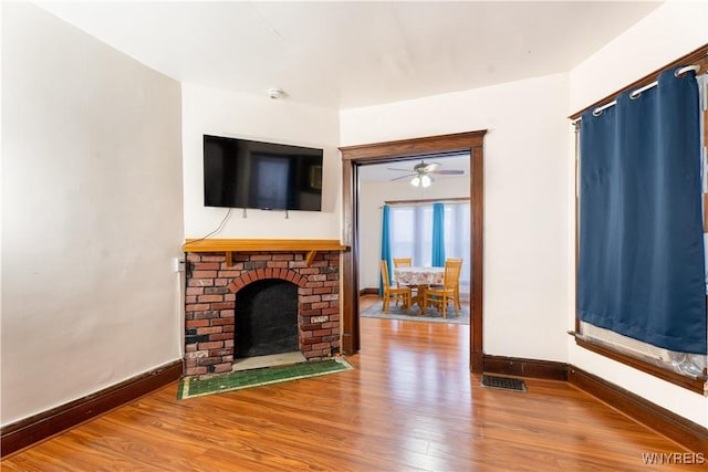 living room with hardwood / wood-style flooring and a fireplace