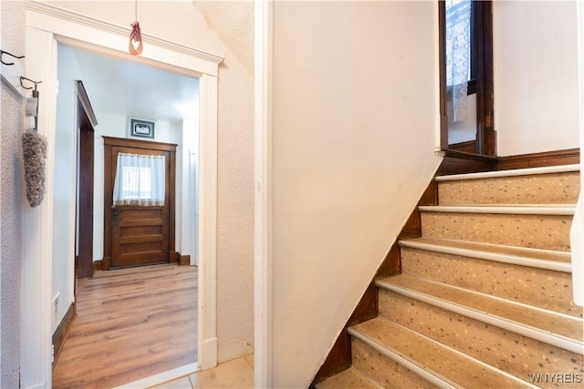 stairs featuring wood-type flooring