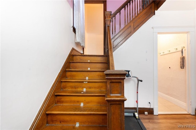 stairs featuring hardwood / wood-style floors