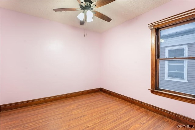 spare room featuring ceiling fan, a textured ceiling, and light hardwood / wood-style flooring