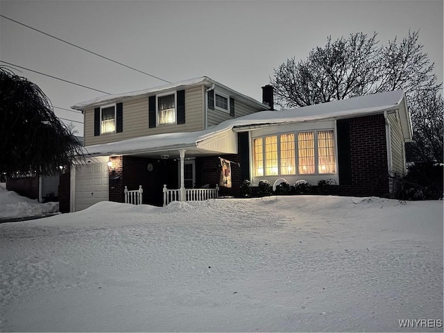 view of front of home with a garage and a porch