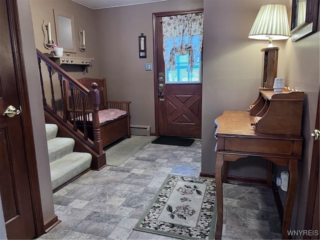 foyer entrance featuring a baseboard heating unit