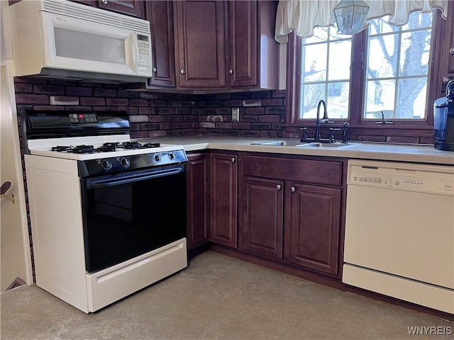 kitchen featuring sink, white appliances, and decorative backsplash