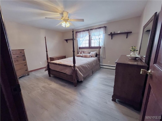 bedroom with baseboard heating, ceiling fan, and light hardwood / wood-style floors