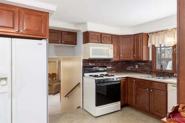 kitchen with tasteful backsplash, white appliances, and sink