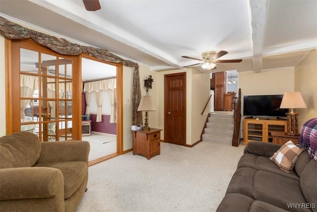 living room with light carpet, beamed ceiling, and ceiling fan