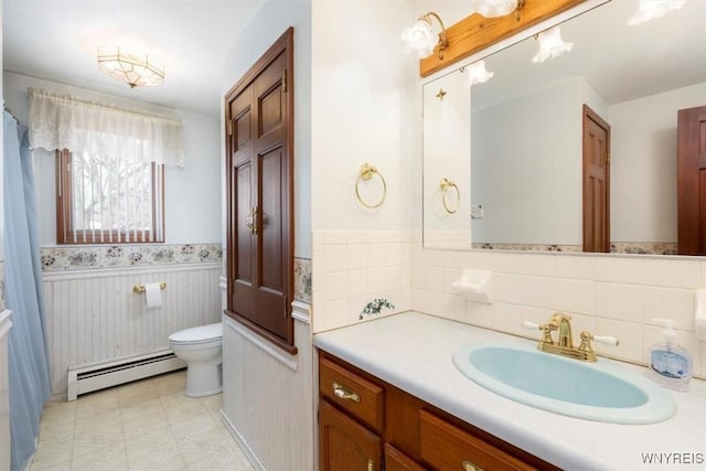 bathroom featuring vanity, a baseboard heating unit, and toilet