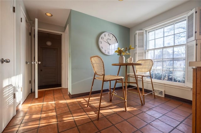 living area with tile patterned floors