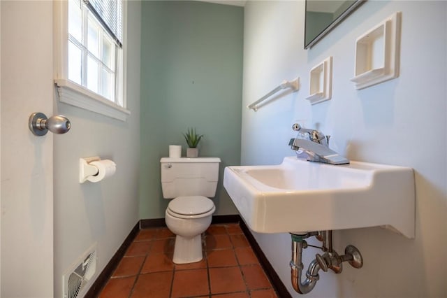 bathroom featuring tile patterned floors, toilet, and sink