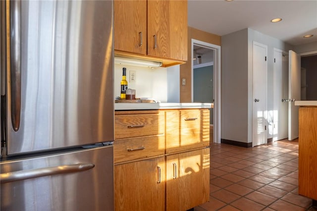 kitchen with stainless steel refrigerator and tile patterned floors