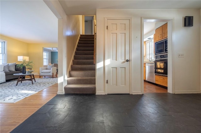 staircase with hardwood / wood-style flooring