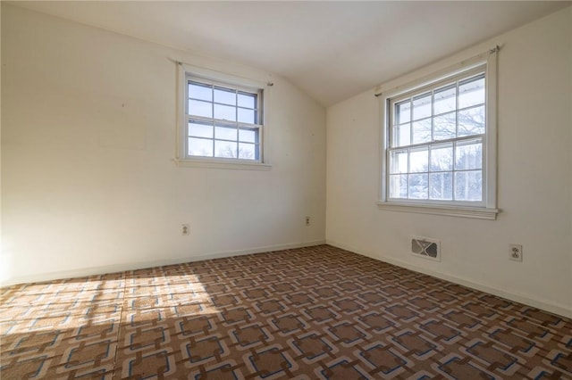 unfurnished room featuring vaulted ceiling