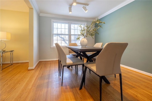 dining room with track lighting, ornamental molding, light hardwood / wood-style floors, and ceiling fan