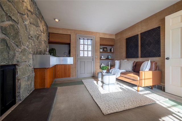 living room with a stone fireplace