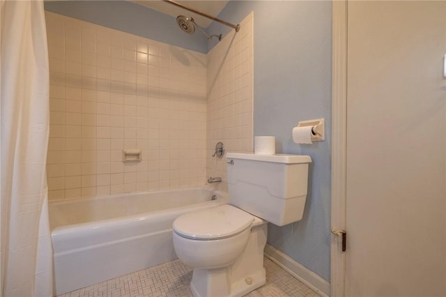 bathroom with toilet, tile patterned flooring, and shower / bath combo