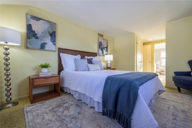 carpeted bedroom featuring ensuite bathroom