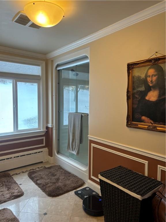 bathroom with crown molding and a baseboard heating unit