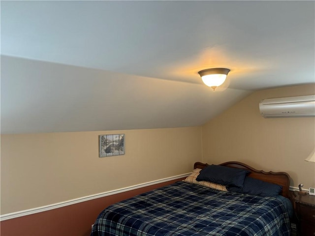 bedroom with lofted ceiling and a wall mounted AC