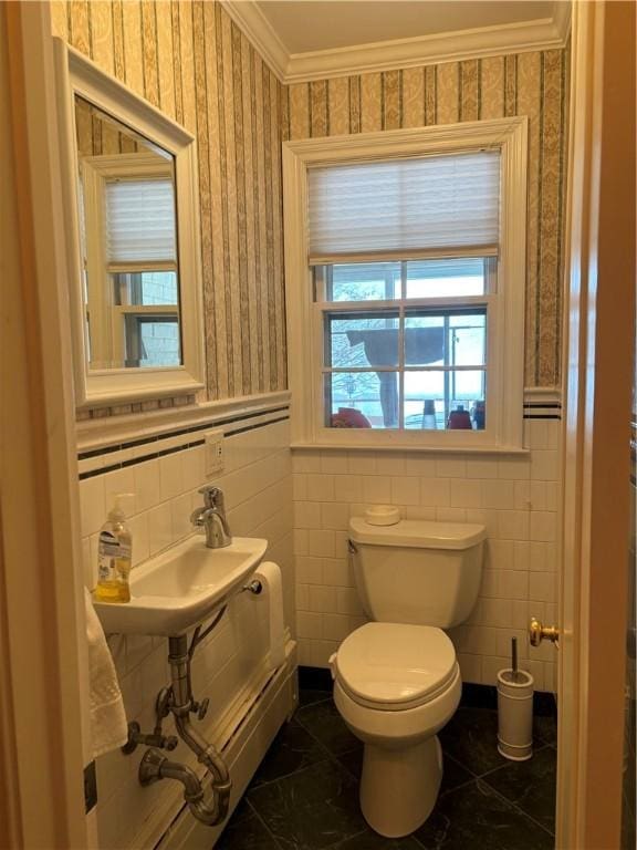 bathroom featuring ornamental molding, sink, tile walls, and toilet