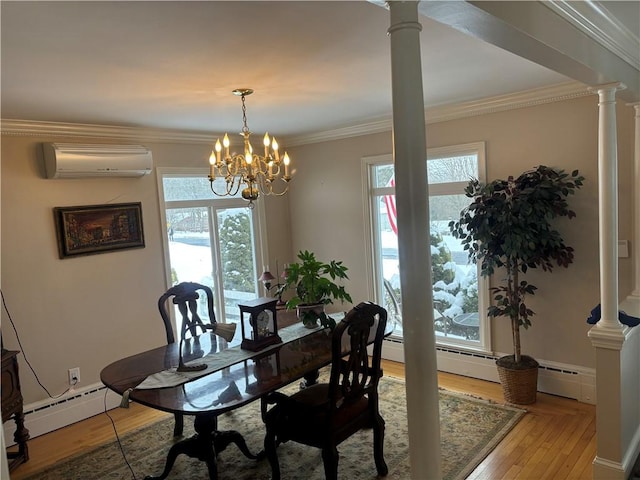 dining space featuring ornate columns, ornamental molding, a wall mounted AC, and light wood-type flooring