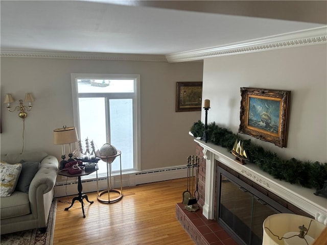 living area with a tiled fireplace, wood-type flooring, ornamental molding, and baseboard heating