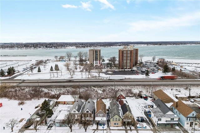 snowy aerial view with a water view