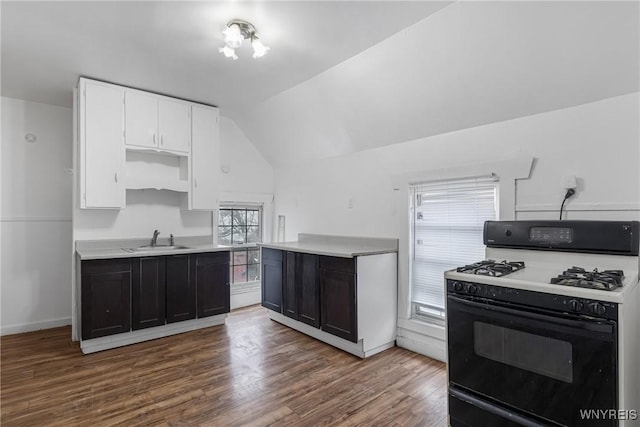 kitchen with lofted ceiling, sink, white cabinetry, gas stove, and dark hardwood / wood-style flooring