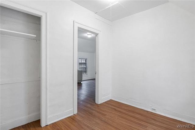 unfurnished bedroom featuring wood-type flooring and a closet