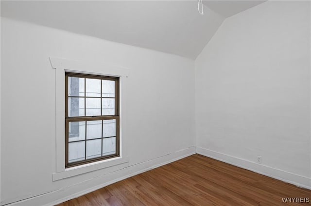 empty room featuring hardwood / wood-style floors and vaulted ceiling